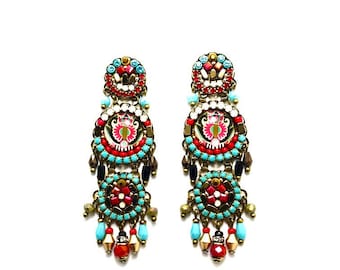 May include: A pair of long, colorful dangle earrings with multiple layers of beads and intricate designs. The earrings feature a mix of red, blue, green, and gold beads.