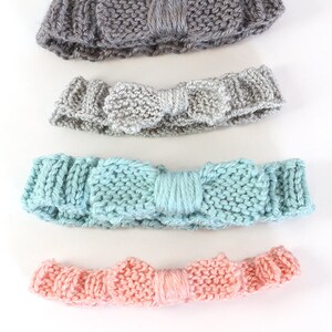 four different knit baby bow headbands on a  white background lined up in a row in the colors light pink light teal light gray and dusty medium purple