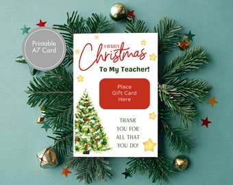 Peut inclure: Carte de Noël imprimable avec une illustration aquarelle d'un sapin de Noël et le texte "Joyeux Noël à mon professeur !" avec un espace pour placer une carte cadeau. La carte a un fond rouge et blanc avec des étoiles dorées.