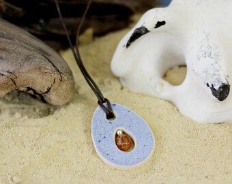 Necklace, pendant with amber, ceramics, leather cord