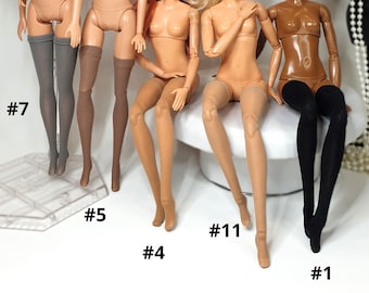 May include: Five nude dolls with different hair colors and skin tones wearing various styles of stockings. The dolls are sitting on a white surface with the numbers #7, #5, #4, #11, and #1 written below them.