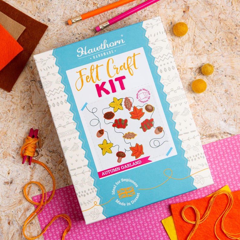 May include: A blue box with the text "Hawthorn Handmade Felt Craft Kit" and a picture of a felt autumn garland. The box also says "Autumn Garland" and "Ideal for Beginners".