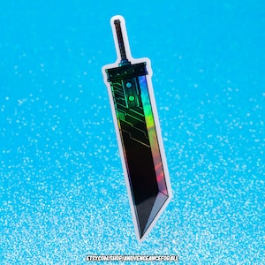 May include: A holographic sticker of a black sword with green and blue accents. The sword has a detailed design and a sharp point. The sticker is on a blue background.