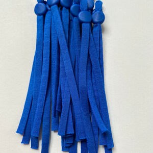 May include: A bundle of 15 royal blue elastic straps with adjustable toggles. The toggles are made of a smooth, hard plastic and are a slightly darker shade of blue than the straps.