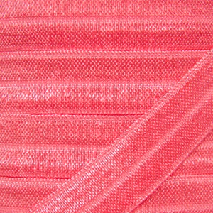 May include: Close-up of a spool of pink elastic ribbon. The ribbon is folded and has a shiny, satin-like finish.