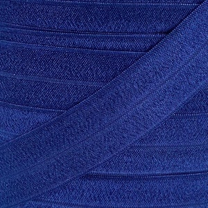 May include: A close-up of a roll of dark blue elastic ribbon. The ribbon is folded in half and the edges are visible.