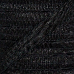 May include: Black elastic ribbon with a textured surface. The ribbon is folded and stacked, showing the texture and the way it drapes.