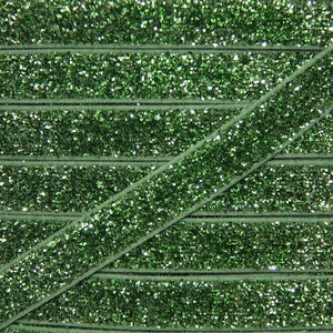 May include: Green glitter ribbon with a velvet texture. The ribbon is folded in a diagonal pattern, showing multiple layers of the glitter fabric.