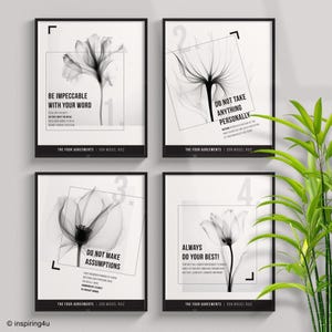 May include: Four framed art prints with black frames. Each print features a grayscale floral image and a quote from "The Four Agreements" by Don Miguel Ruiz. The quotes include "Be Impeccable With Your Word" and "Do Not Take Anything Personally."