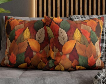 May include: Two decorative throw pillows with a fall leaf pattern. The pillows feature a variety of colors, including red, orange, yellow, brown, and green. The leaves are arranged in a random pattern, creating a visually appealing design.