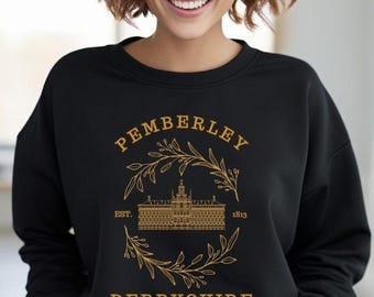 May include: Black sweatshirt with a gold design featuring the word "PEMBERLEY" above an illustration of a building, surrounded by a wreath. The text "EST. 1813" and "DERBYSHIRE" are also included in the design.