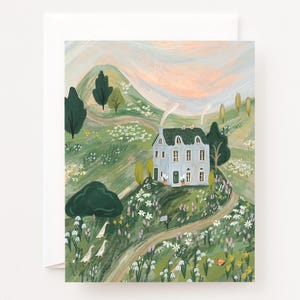 May include: An art print depicting a light blue house with a grey roof, set in a green valley with winding paths. The landscape includes trees, flowers, and a soft, pastel sky. Two white birds are in the foreground.