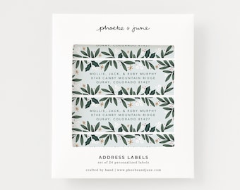 May include: Set of 24 personalized address labels with a festive holly and berry design. The labels feature a blue background with green leaves, red berries, and gold stars. The text on the labels reads "Mollie, Jack, & Ruby Murphy, 8748 Canby Mountain Ridge, Ouray, Colorado 81427".