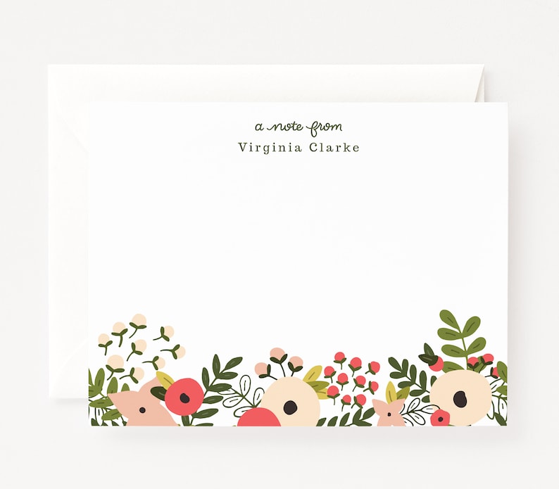 May include: A note card with a floral border. The border features pink, white, and green flowers. The text "a note from Virginia Clarke" is printed at the top of the card.