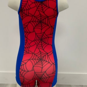 May include: A red and blue leotard with a spiderweb design. The leotard has a scoop neck and a racerback style.