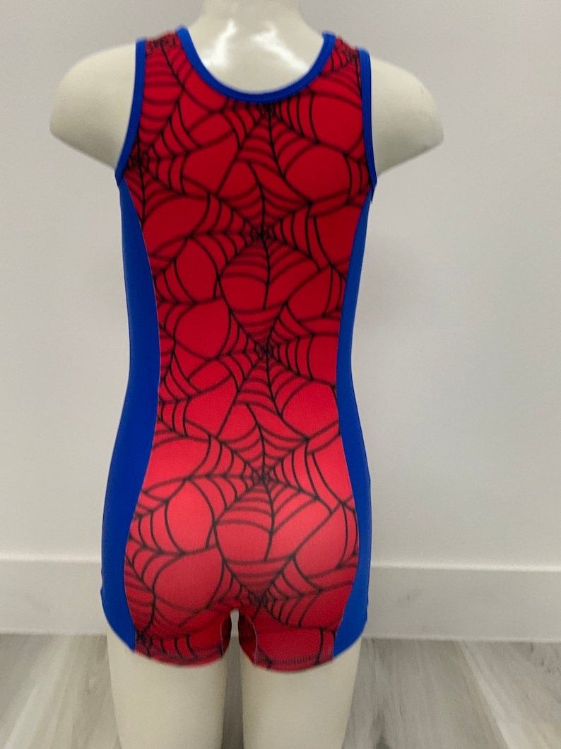 May include: A red and blue leotard with a spiderweb design. The leotard has a scoop neck and a racerback style.