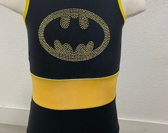 May include: Black leotard with a yellow trim and a gold glitter Batman logo.