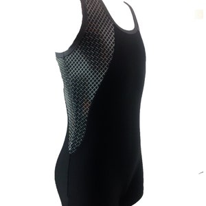 May include: Black sleeveless leotard with a geometric pattern on the side. The leotard has a scoop neck and a fitted silhouette.