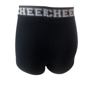 May include: Black athletic shorts with a white band at the waist. The band features the word "CHEECH" in a bold, block letter font. The shorts are made of a smooth, stretchy fabric.