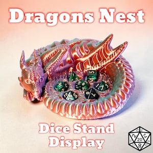 May include: A dragon-shaped dice stand in shades of red, purple, and green, with the text "Dragons Nest" and "Dice Stand Display." The stand holds several green dice with white numbers. A D20 die is in the lower right corner.