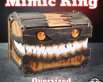 May include: A wooden chest with a menacing design, featuring a hinged lid and a wide, toothy maw. The chest has two glowing orange eyes and the text "Mimic King" and "Oversized Mimic Chest". The chest is designed for tabletop gaming.
