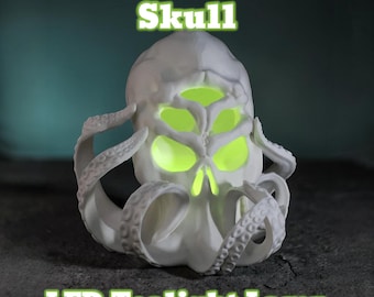 May include: A white Cthulhu skull LED tealight lamp. The skull has glowing green eyes and tentacles. The text "Cthulhu Skull" and "LED Tealight Lamp" are in green.