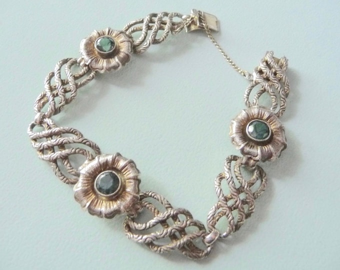 Silver bracelet decorated with 3 green crystals. Vintage.