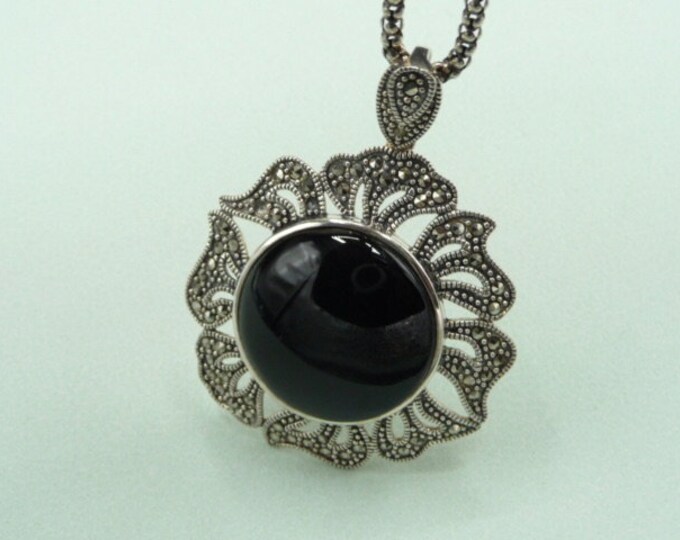 Silver and onyx pendant, decorated with small brilliants. Vintage.