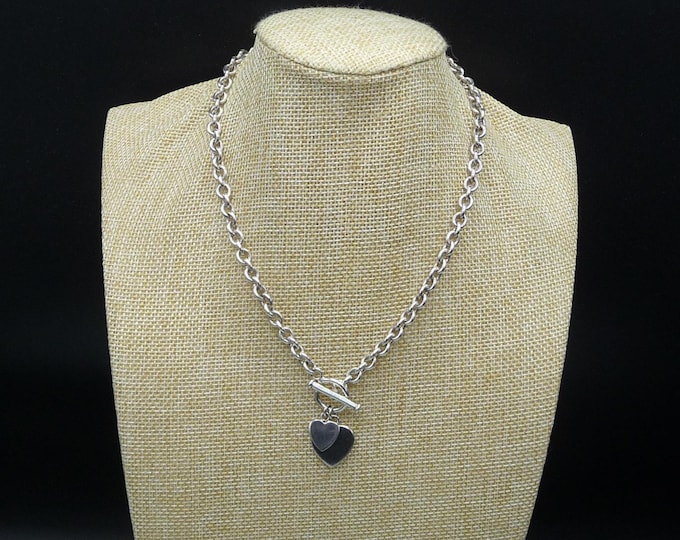 Vintage 925 sterling silver necklace with heart-shaped charms.