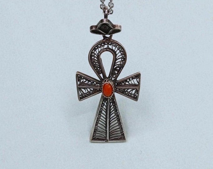 Silver pendant decorated with a coral cabochon. Vintage.