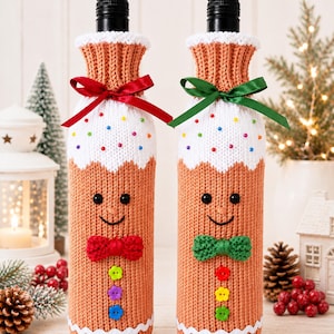 May include: Two knitted bottle covers shaped like gingerbread people. Each cover is light brown with a white top featuring colourful sprinkles, a black stitched face, a bow tie, and three small buttons. One has a red bow and one has a green bow.