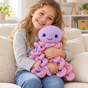 May include: A plush octopus toy crafted from soft, textured yarn in a vibrant lavender purple color. The octopus features a rounded head, large dark blue eyes with light blue irises, a stitched black mouth, and multiple curly tentacles with peach-colored undersides.