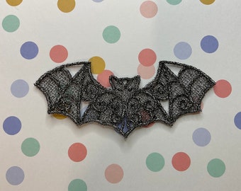 Itty Bitty Bat metallic black and silver lacework brooch.