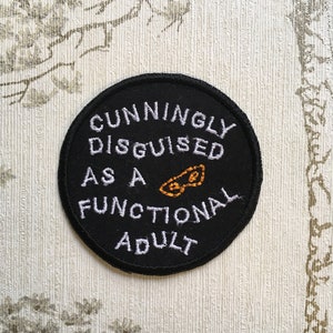 Embroidered merit iron on patch: Cunningly disguised as a functional adult. image 1