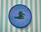 Embroidered cryptid iron on patch: Kelpie Diving Club.