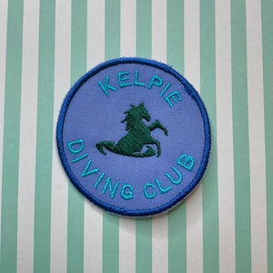 Embroidered cryptid iron on/sew on patch: Kelpie Diving Club.
