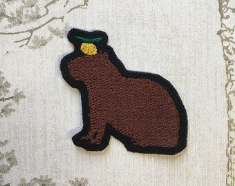 Embroidered whimsy iron on patch: Capybara and yuzu.