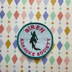 Embroidered cryptid iron on/sew on patch: Siren karaoke society.