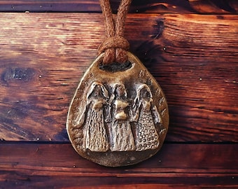 Triple goddess amulet made of bronze.