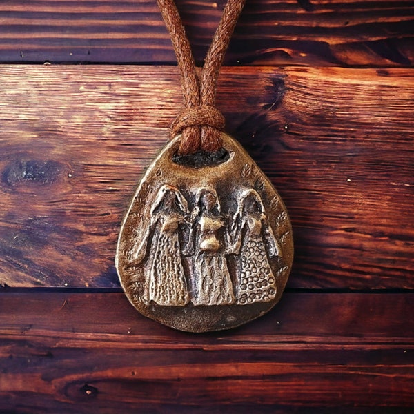 Triple goddess amulet made of bronze.