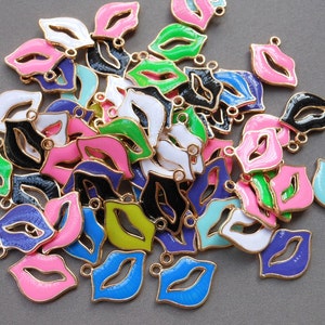 May include: A large pile of colorful enamel lip charm pendants. The charms are gold-toned with a variety of colors including pink, blue, green, black, and white.