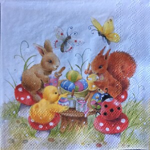 May include: A colorful Easter scene with a brown bunny, a red squirrel, a yellow chick, and a ladybug, all painting Easter eggs on a wooden table. The animals are sitting on red and white mushroom stools.