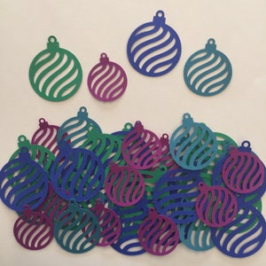 May include: A collection of paper ornaments in blue, green, and purple. The ornaments are cut out in the shape of a Christmas tree ornament and have a swirl pattern.