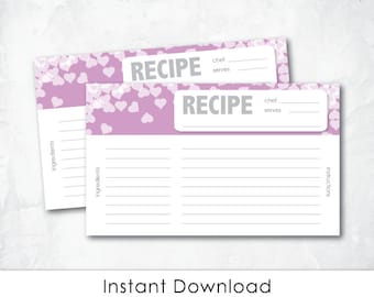 May include: Printable recipe cards with a pink background and white hearts. The cards have lines for writing the recipe name, chef, servings, ingredients, and instructions. The text "RECIPE" is printed in gray on the cards.