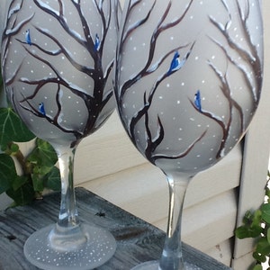 Hand painted blue birds in snow capped trees in a winter scene, Enjoy your favorite wine in our new 19 oz. glass, price is for one glass