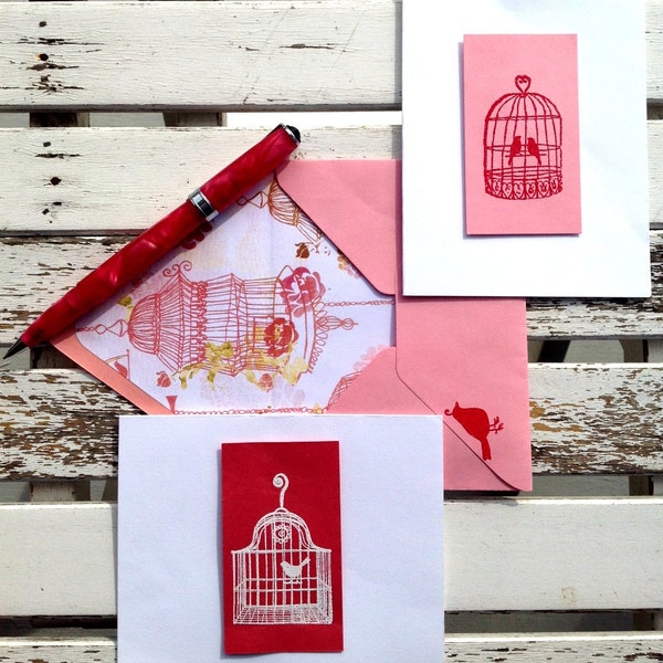 Birds in bird cages hand stamped and embossed on pinks & white cards with a birdcage lined envelope.