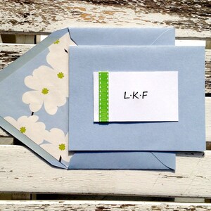 Personalized white card with green pick stitch ribbon on a white card with a coordinating lined envelope.