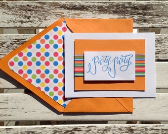 Party Party invitation with multi stripe ribbon. White card with polka dottted lined orange envelope.