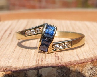 Gold topaz ring. A 14k yellow gold blue topaz and diamond ring