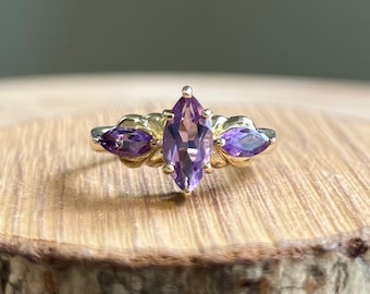 Gold amethyst ring. A 9k yellow gold marquis cut 1.5 carat natural amethyst trilogy ring